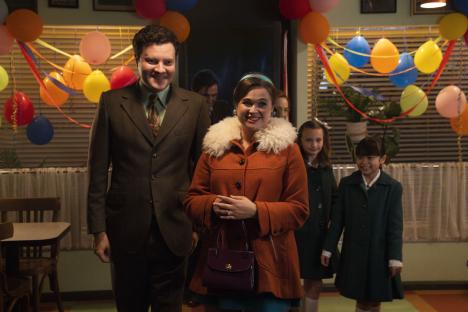 Scene from Call the Midwife featuring two adults and two children at a birthday party.