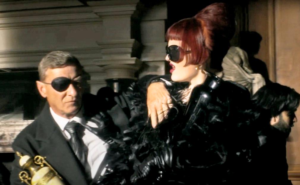 Scene from a TV show trailer showing people at a funeral.