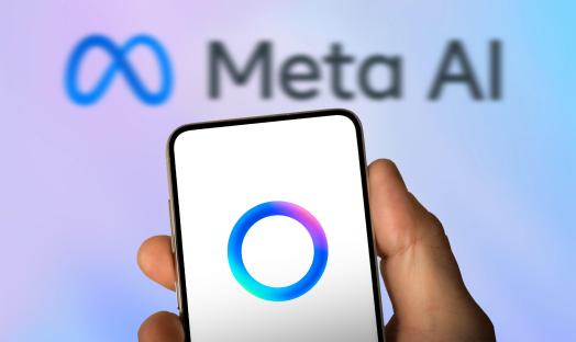 Smartphone displaying the Meta AI logo with the Meta AI logo blurred in the background.