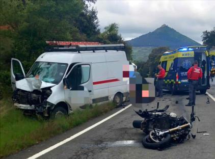 Accident scene showing a damaged van and motorcycle.