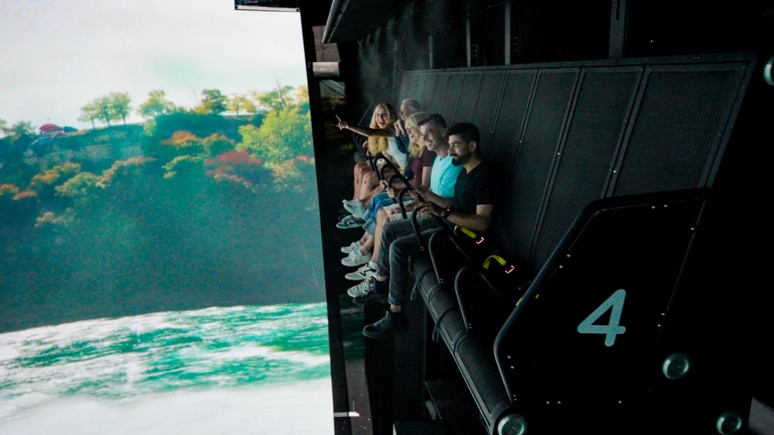 Niagara Falls flight simulation ride: people seated in gondola-style seats enjoying the view.