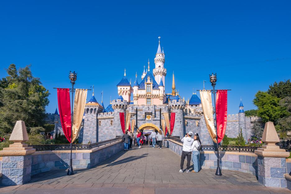 Sleeping Beauty Castle at Disneyland, with visitors approaching the entrance.