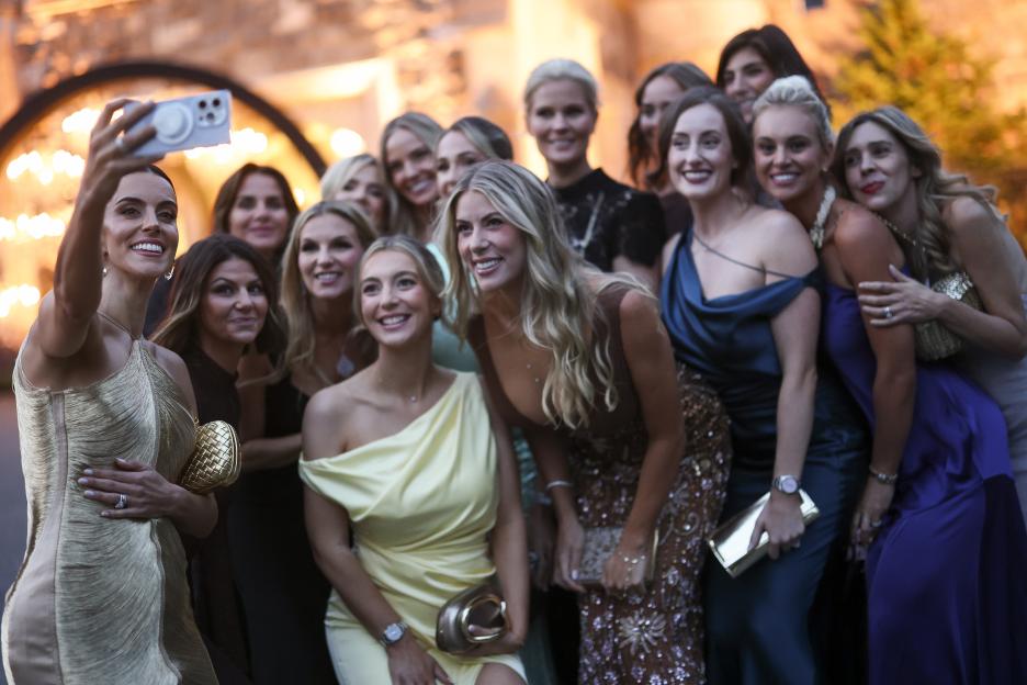 Diane Donald, wife of Captain Luke Donald, taking a selfie with other partners of Team Europe during the Ryder Cup Teams' Welcome Dinner.