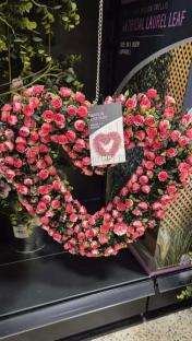 Heart-shaped wreath of pink artificial roses.