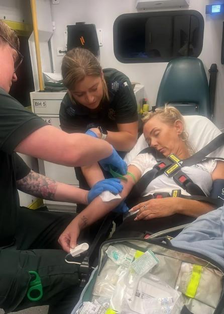 Paramedics attending to a patient in an ambulance.