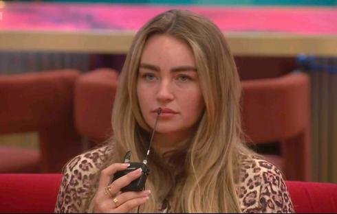 Ella Rae Wise on Celebrity Big Brother, holding a microphone.
