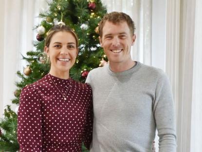 Rohan Dennis and his wife Melissa Hoskins by a Christmas tree.