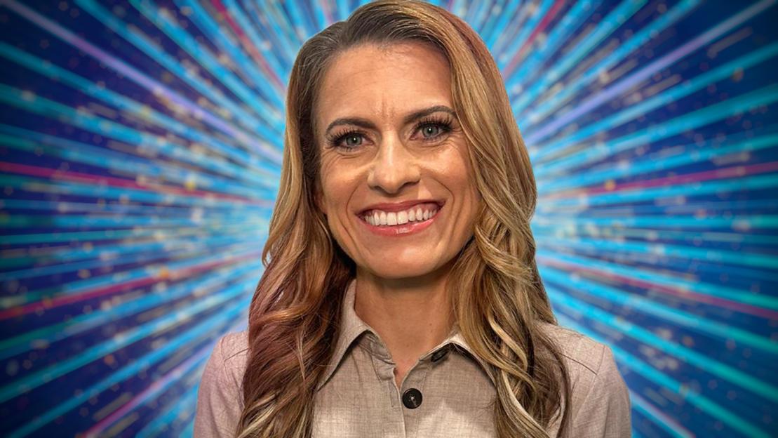 Portrait of a smiling woman in front of a sparkly background.
