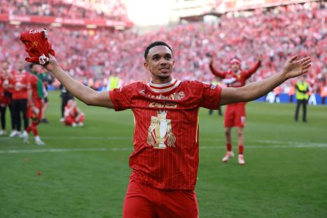 Trent Alexander-Arnold celebrates on a soccer field.