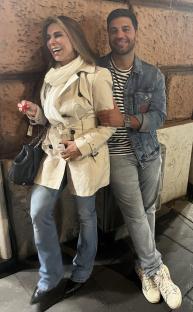 A woman and a man standing close together.
