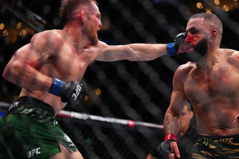 Jack Della Maddalena punches Belal Muhammad in a UFC welterweight championship bout.