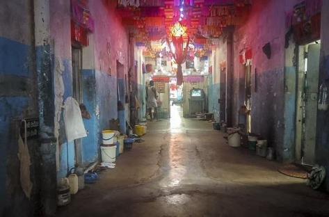 Interior of a maggot-infested prison corridor.