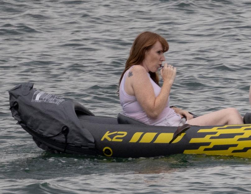 Angela Rayner and a child in a yellow inflatable boat on the water.