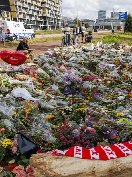 Floral tributes at a murder victim's memorial.