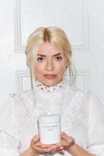 Holly Willoughby holding a WYLDE MOON candle.