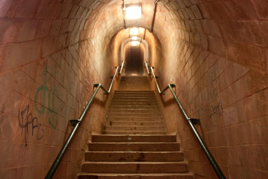 Staircase in a brick tunnel.