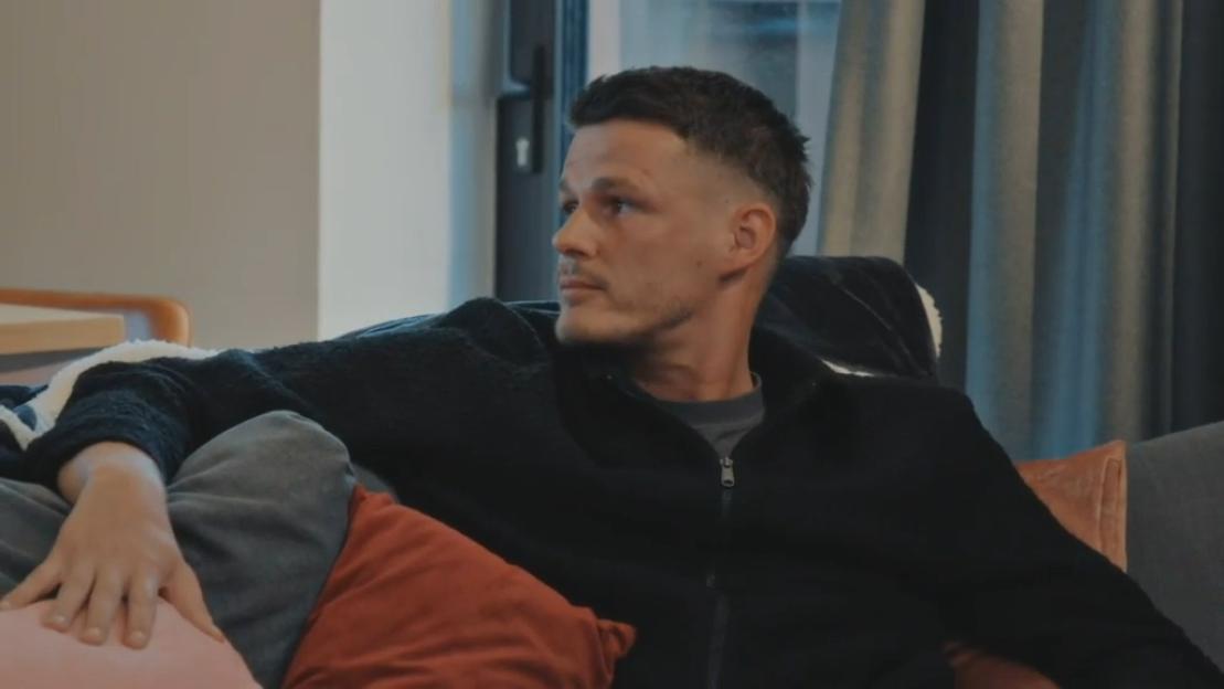 Steven on a couch, looking to the left.