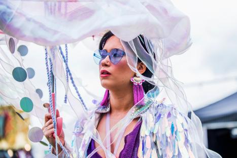 Woman at Shindig Festival holding a jellyfish-shaped umbrella.