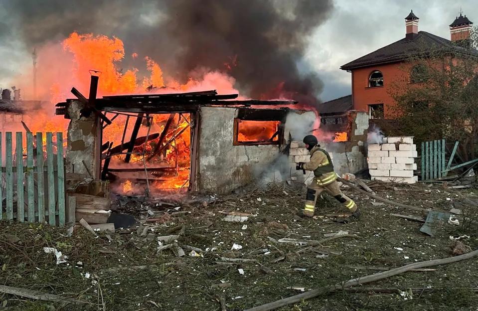 Ukrainian rescuers battling a fire at a damaged building in Zhytomyr.