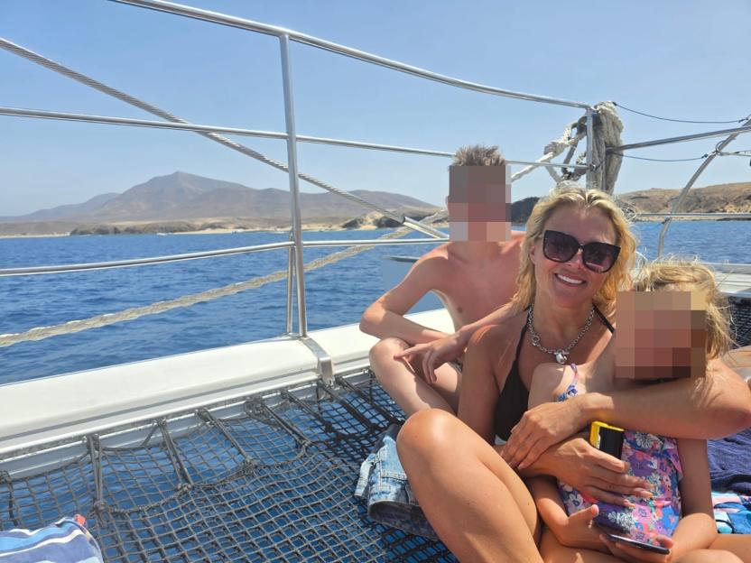 Woman with two children on a boat.