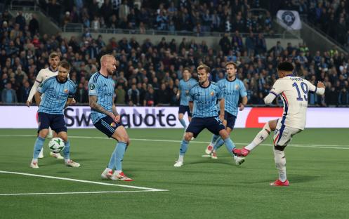 Jadon Sancho scoring a goal during a Djurgarden vs Chelsea soccer match.