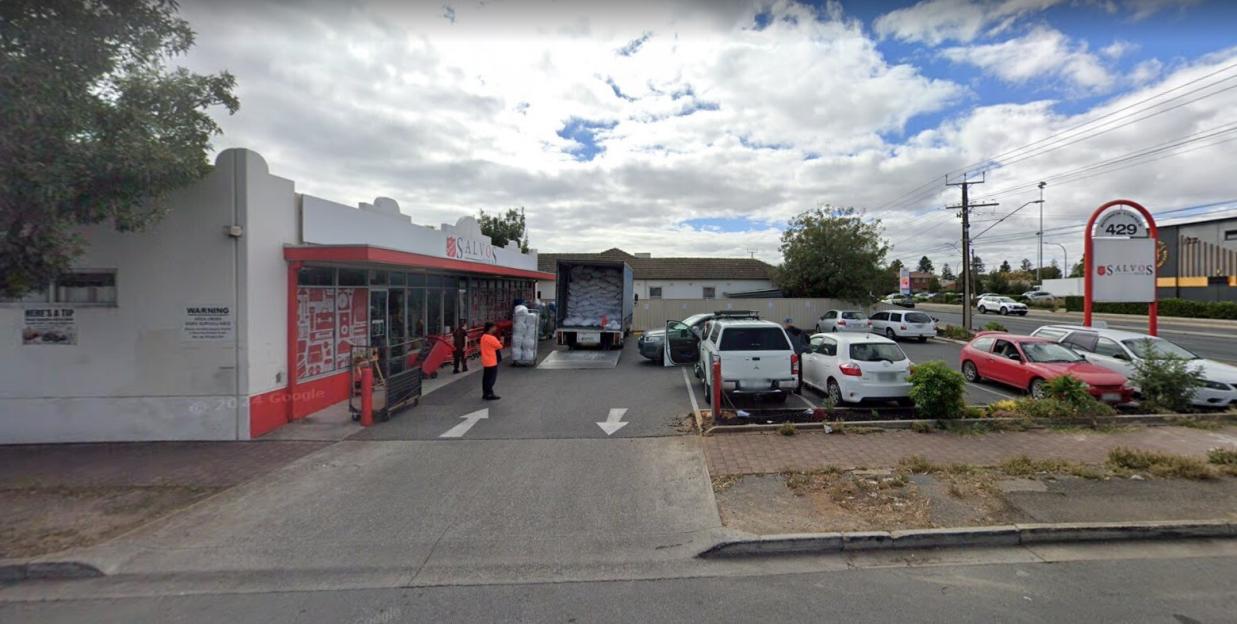 A Salvation Army (Salvos) storefront with a delivery truck backed up to its loading dock.