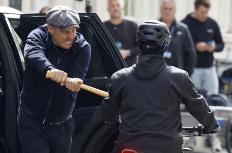 Vinnie Jones on a film set wielding a bat.