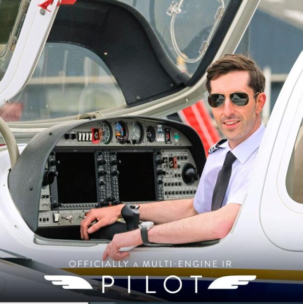 Pilot sitting in the cockpit of a small plane.