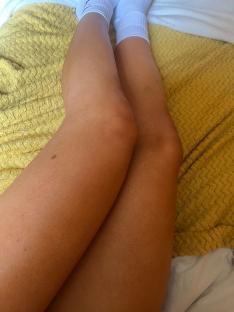 Tan legs resting on a mustard-yellow blanket.
