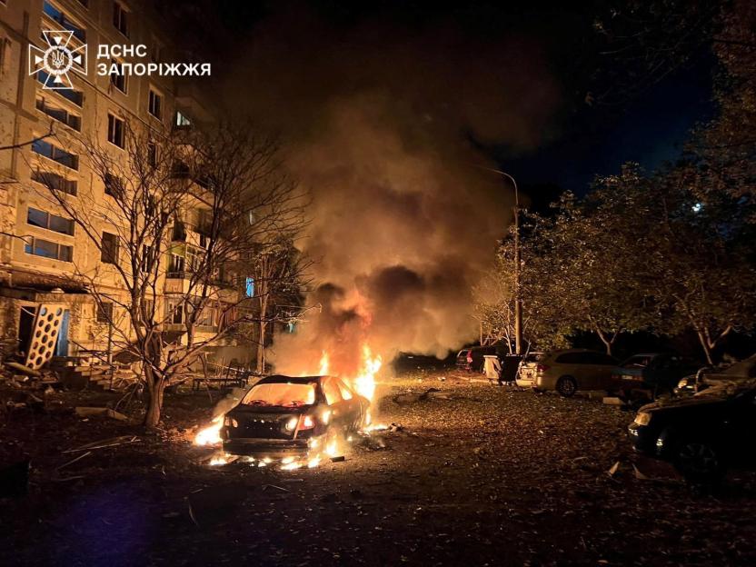 A car burning in front of a damaged apartment building during a Russian drone and air strike in Zaporizhzhia, Ukraine.
