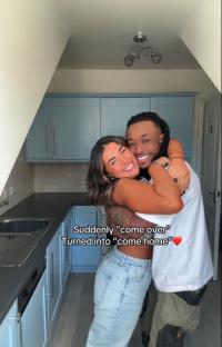 Couple embracing in their new kitchen.