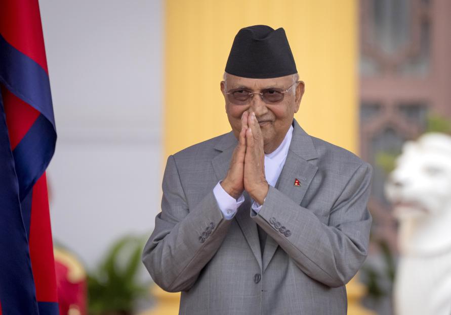 Newly elected Prime Minister Khadga Prasad Oli greets after his oath of office.
