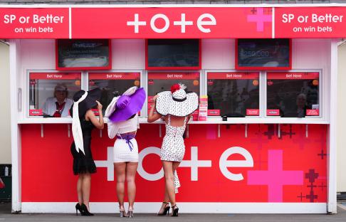 Racegoers place their bets on day two of the 2024 Randox Grand National Festival at Aintree Racecourse, Liverpool. Picture date: Friday April 12, 2024. PA Photo. See PA story RACING Aintree. Photo credit should read: Peter Byrne/PA Wire. RESTRICTIONS: Editorial Use only, commercial use is subject to prior permission from The Jockey Club/Aintree Racecourse.