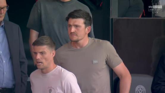Two men standing and talking.