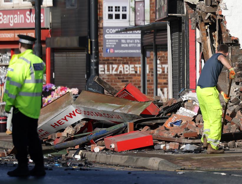 A car crashed into a building on Bridge St in Heywood, leaving debris on the street.