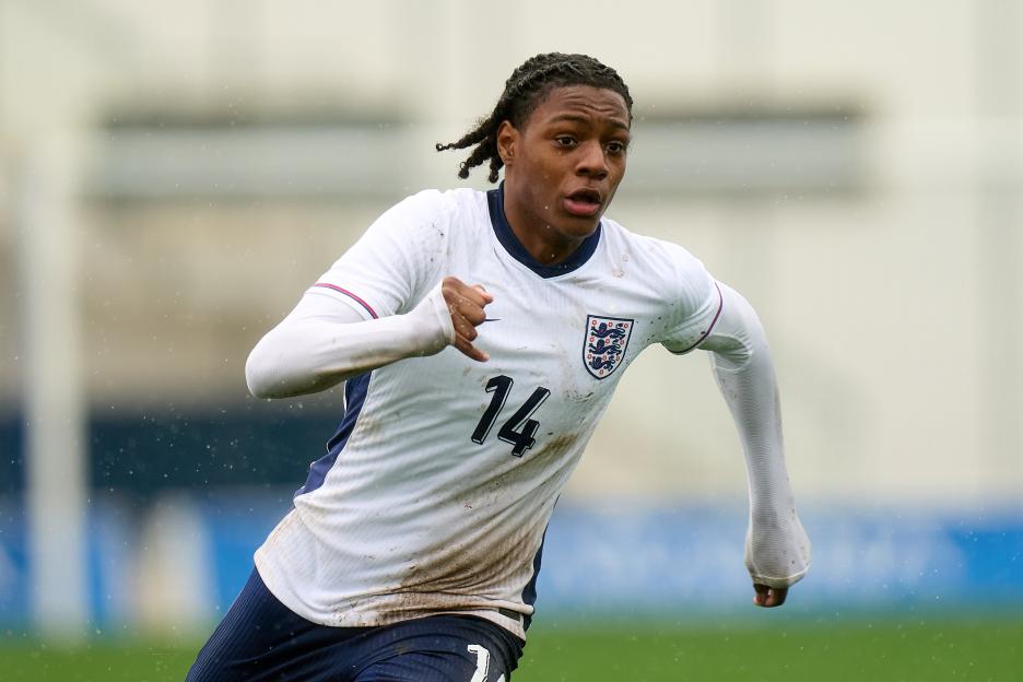 Jashayde Mensah-Greenwood in a white England soccer jersey with mud stains, number 14.