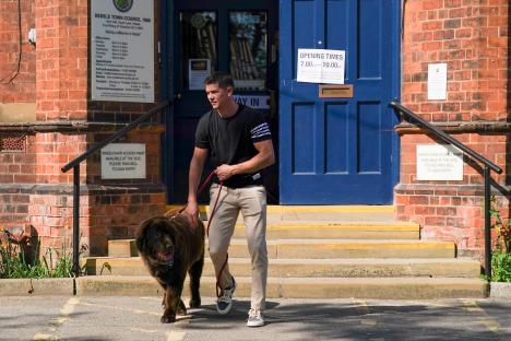 Luke Campbell, Reform UK candidate, walking his dog after voting.