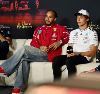 Three Formula 1 drivers at a press conference.