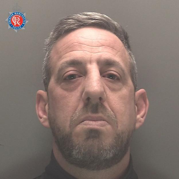 Mugshot of Karl Davies, a man with short graying hair and a beard.