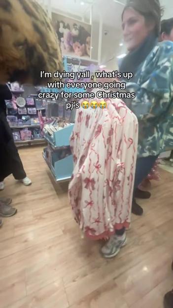 Shoppers fighting over Christmas pajamas in a store.