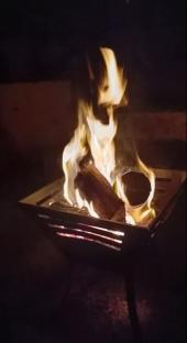 Fire burning in a metal fire pit.