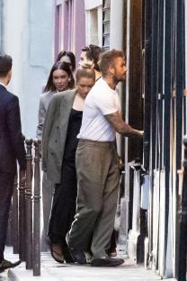 The Beckham family entering a restaurant.