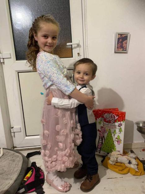 Photo of Lilly and Oliver, two young children, hugging.