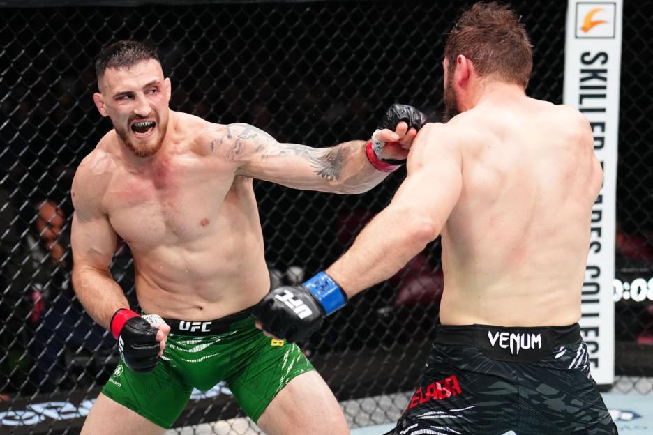 Modestas Bukauskas punches Ion Cutelaba in a UFC light heavyweight bout.