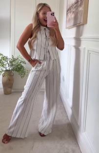Woman modeling a striped pinstripe pantsuit.