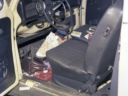 Interior of a Volkswagen with various items including a pack of Eve cigarettes.