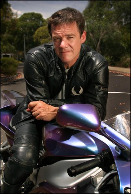 Actor Stefan Dennis sitting on his Yamaha R1 motorcycle.