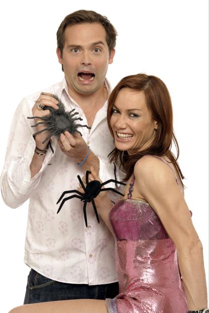 Matt Brown holding a fake spider while Tara Palmer-Tomkinson laughs, promoting "I'm a Celebrity Get Me Out of Here Now!"