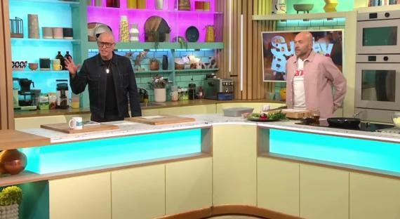 Danny Dyer and another man on a cooking show set.