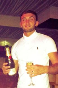 Man holding a champagne bottle and glass.